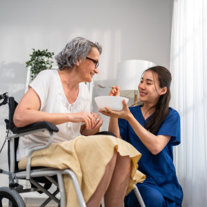 Woman feeding senior