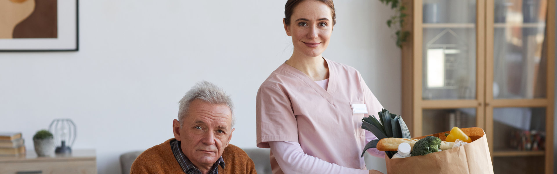 senior sitting and woman standing
