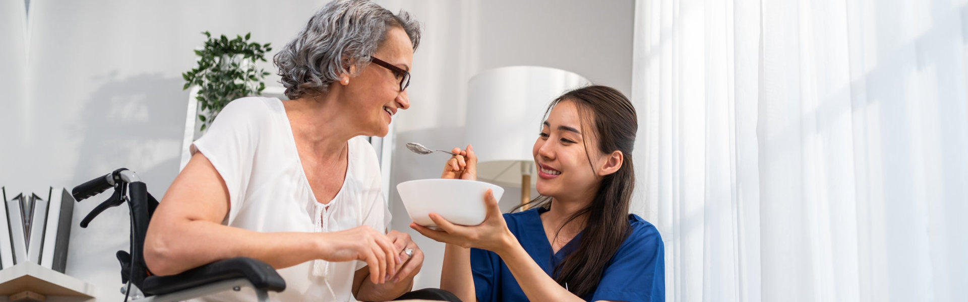 woman feeding senior
